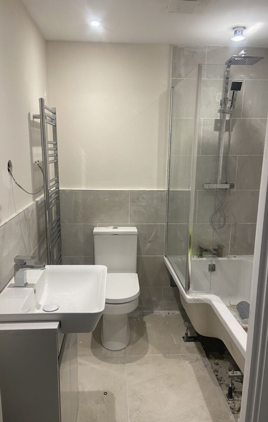 Finished bathroom with shower over bath