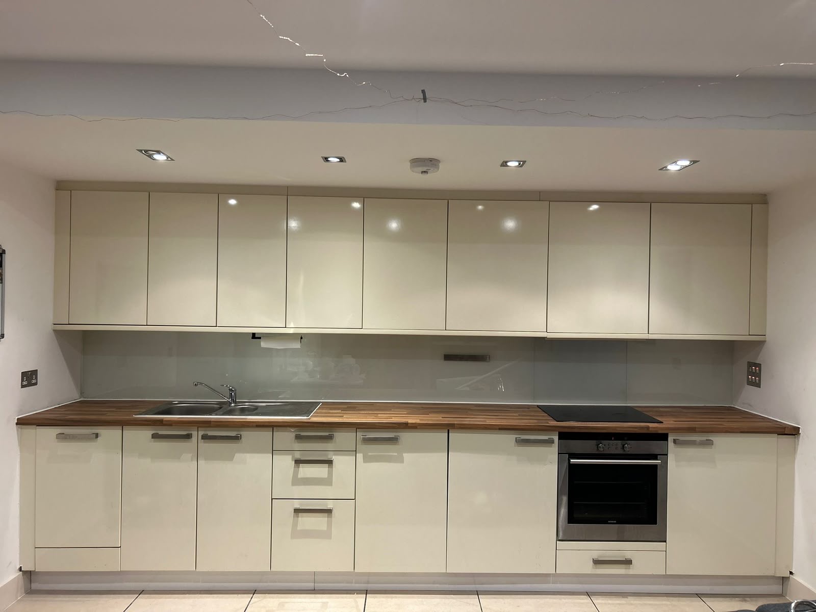 Full kitchen renovation, cream gloss units with wood worktop