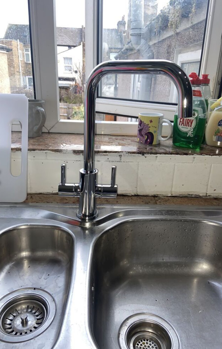 Kitchen tap installation with garden view