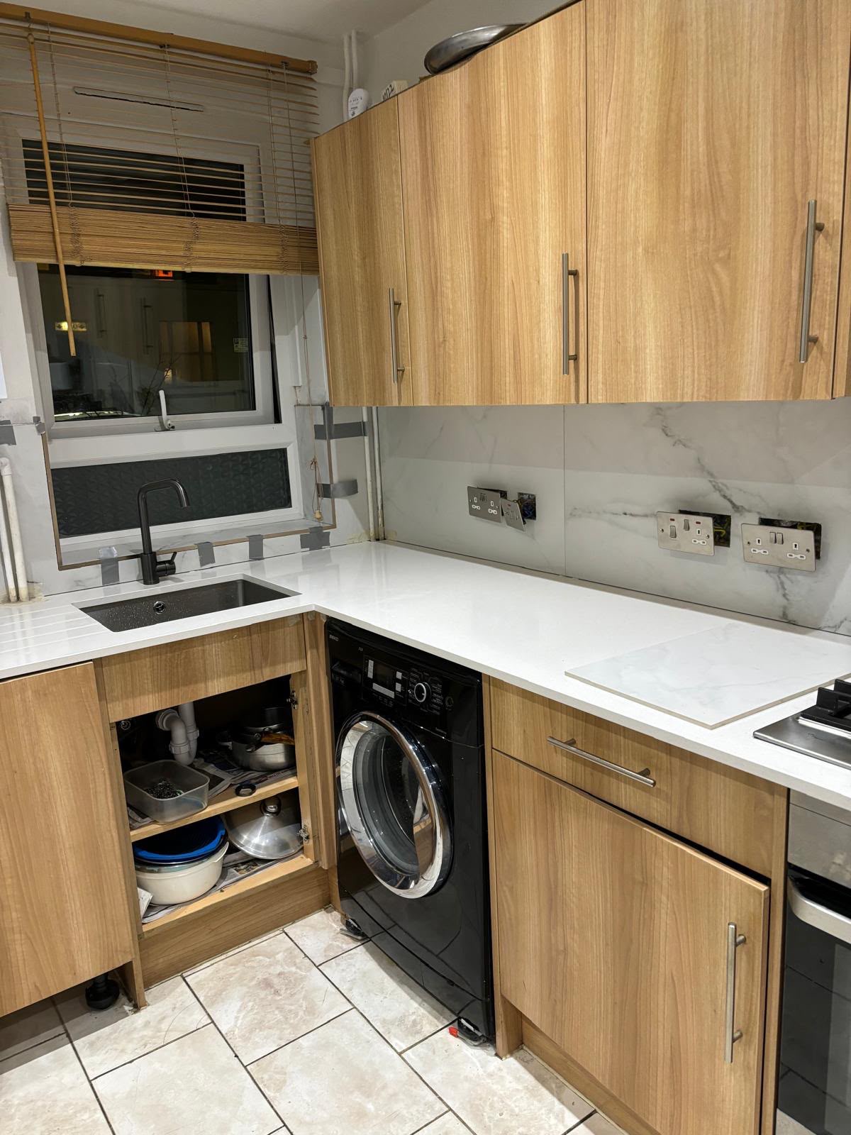 Kitchen after renovation, marble splashback and new sink